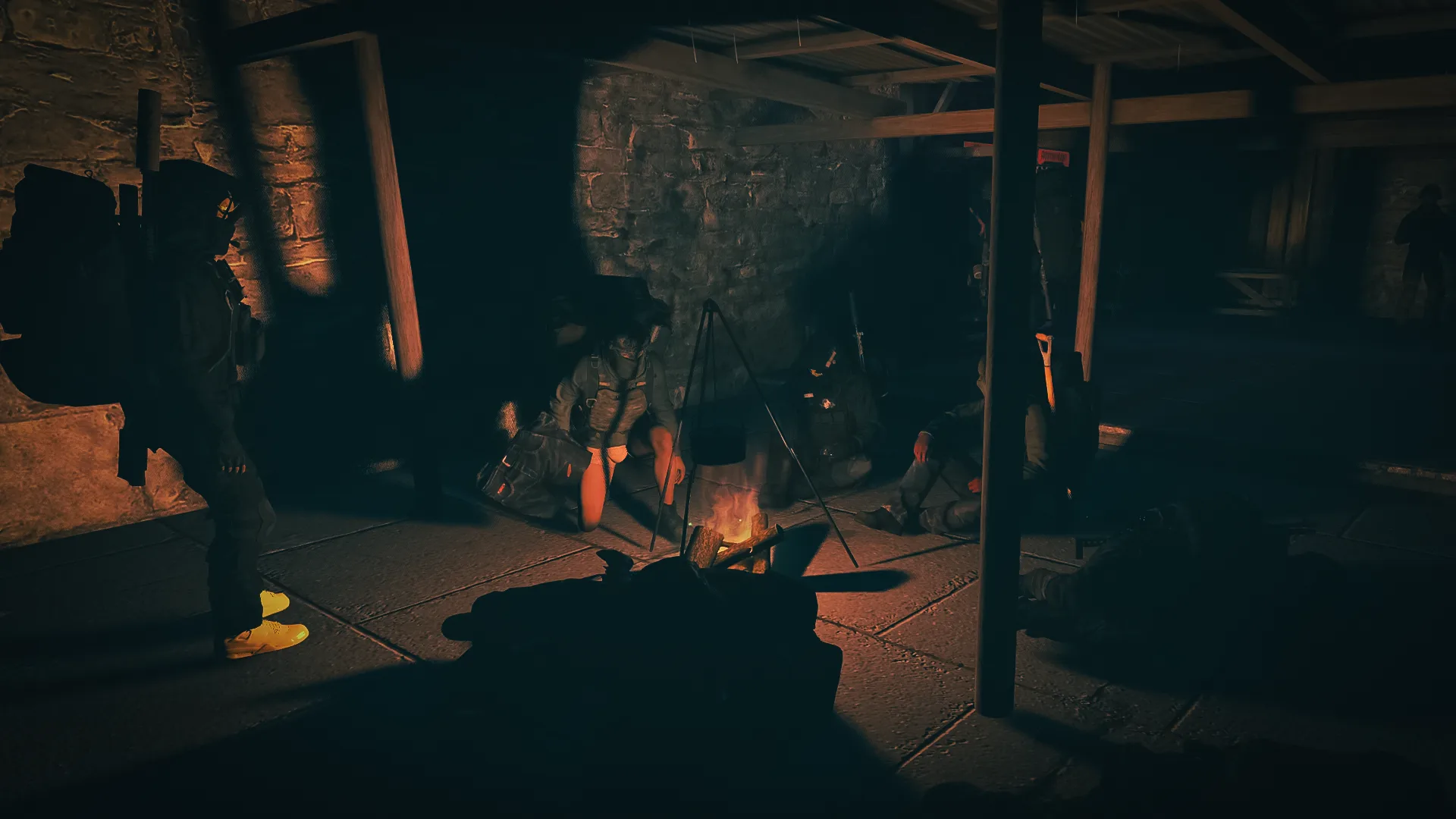 Players gathering around a fire inside a shelter